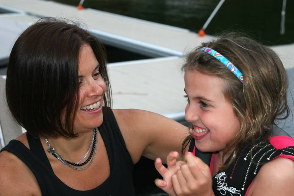 Becky and her daughter Cecilia laughing on a boat