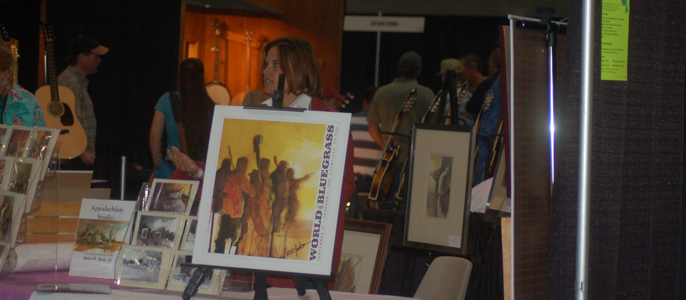 Appalachian Studio booth at IBMA World of Bluegrass with the poster painting on an easel