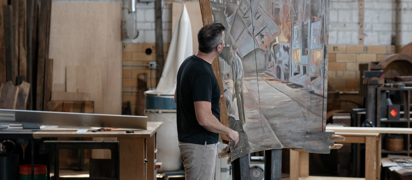 Cory Bonnet moving a large painting in the Patterns of Meaning workshop